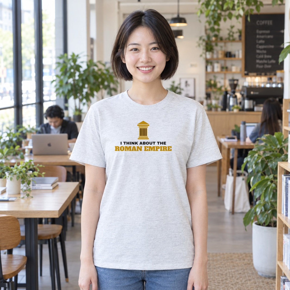 Woman wearing the ash Roman Empire graphic tee
