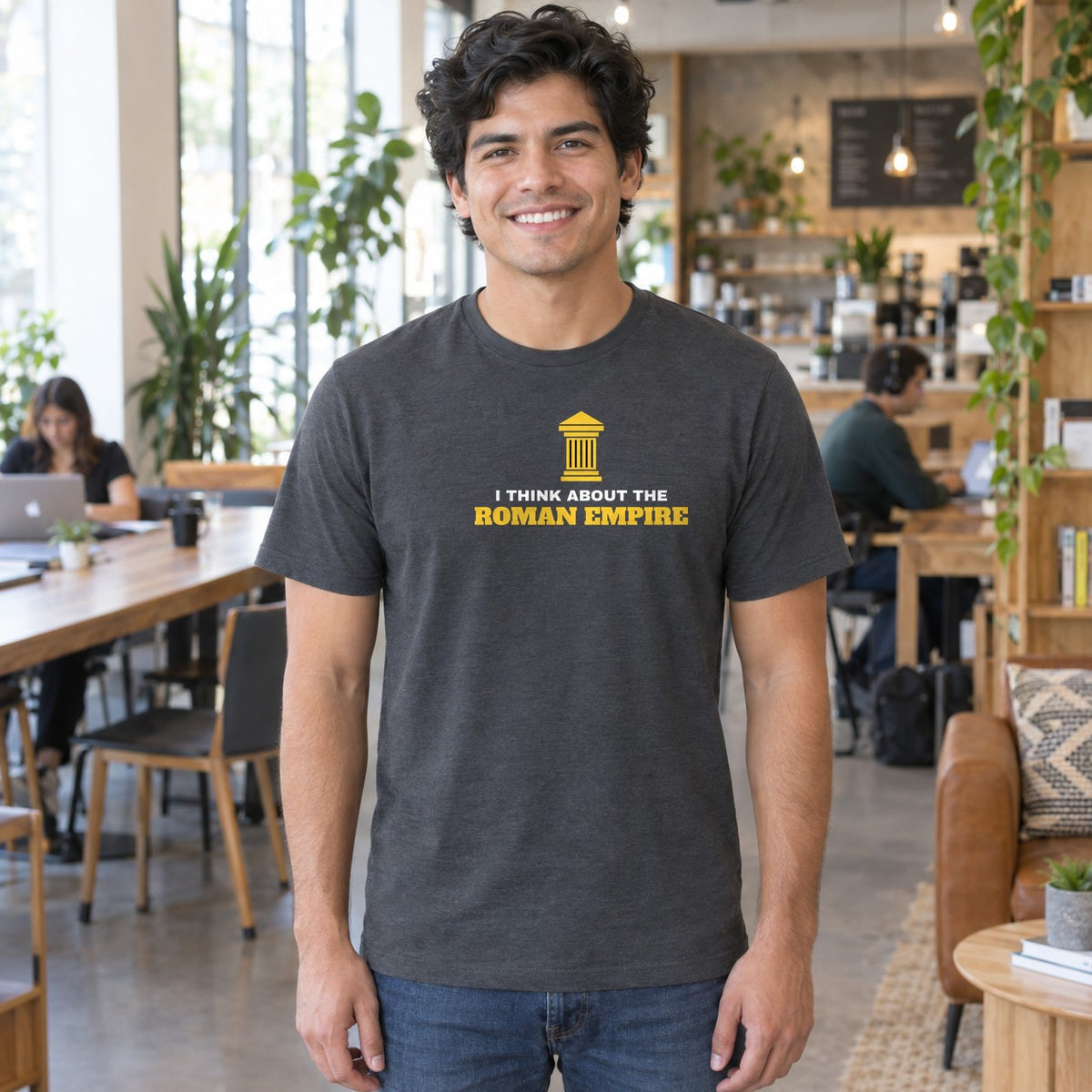 Man wearing the charcoal Roman Empire graphic tee