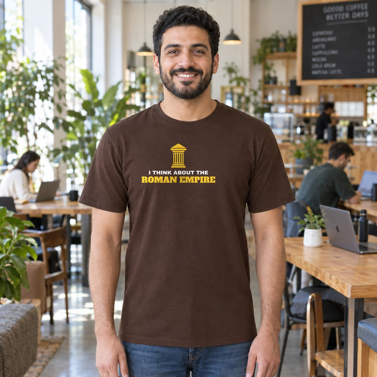 Man wearing the dark chocolate Roman Empire graphic tee