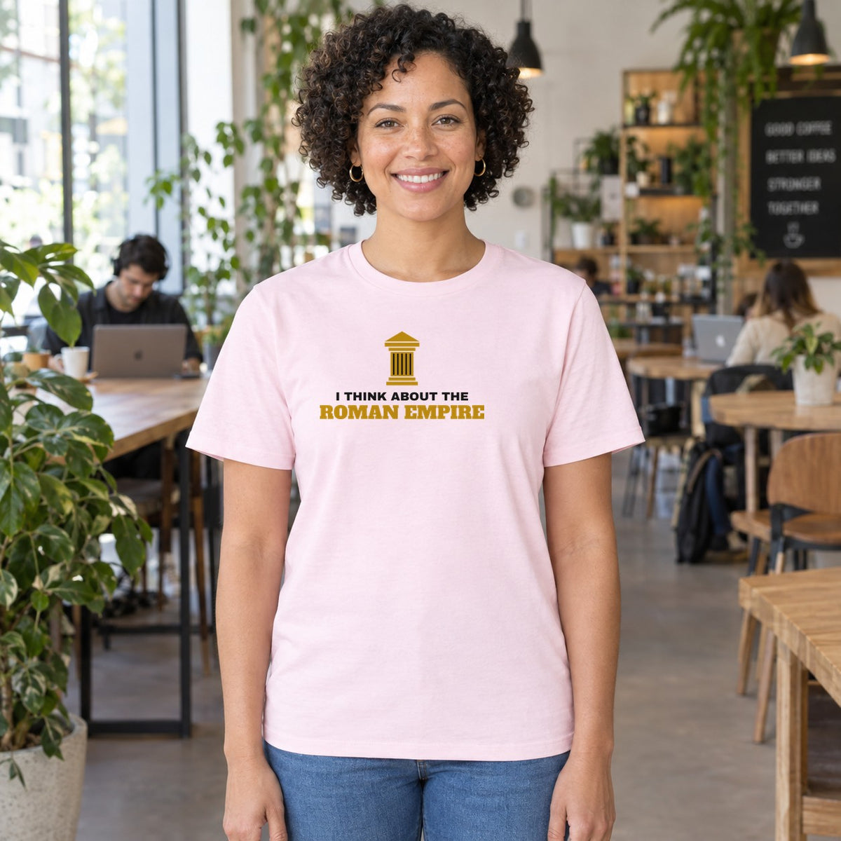 Woman wearing the light pink Roman Empire graphic tee