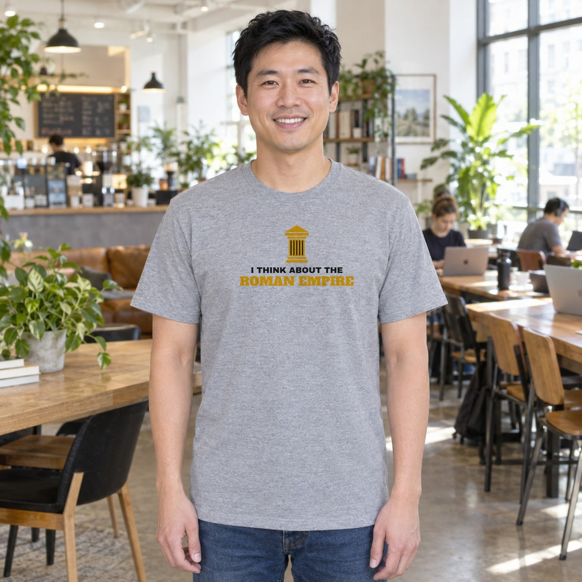 Man wearing the sport grey Roman Empire graphic tee