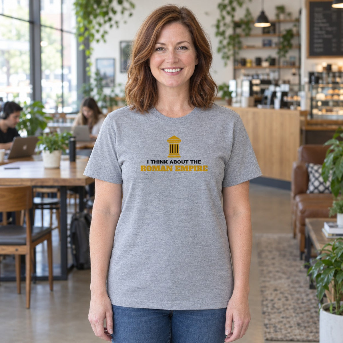 Woman wearing the sport grey Roman Empire graphic tee