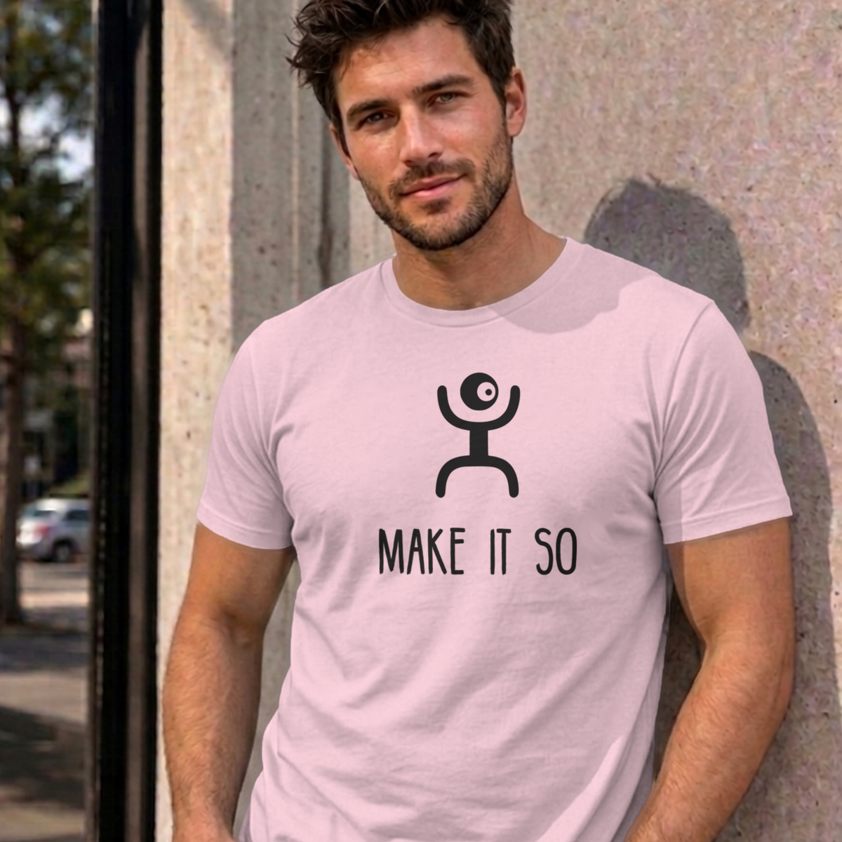 Man wearing the light pink Make It So graphic tee