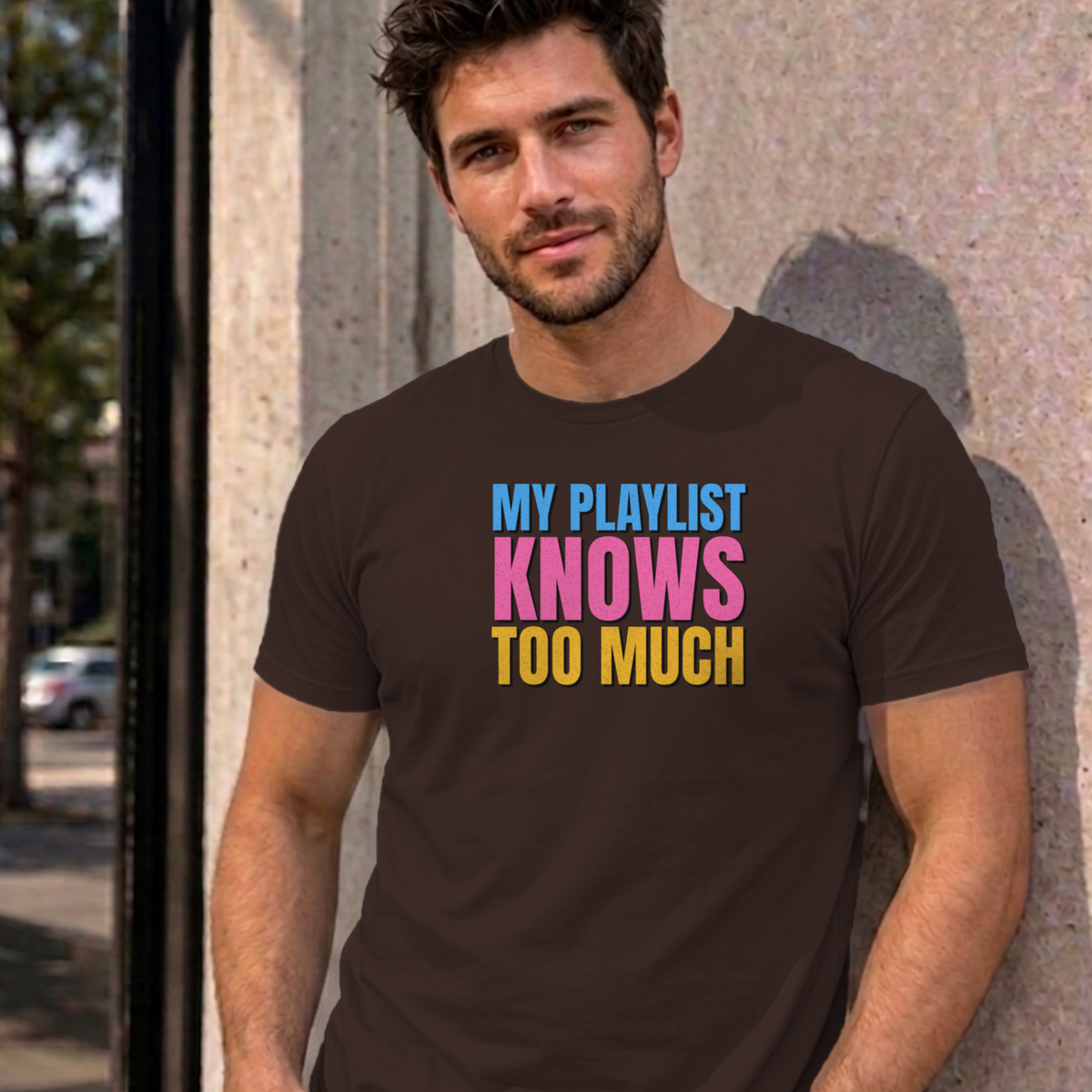 Man wearing the dark chocolate My Playlist Knows Too Much graphic tee
