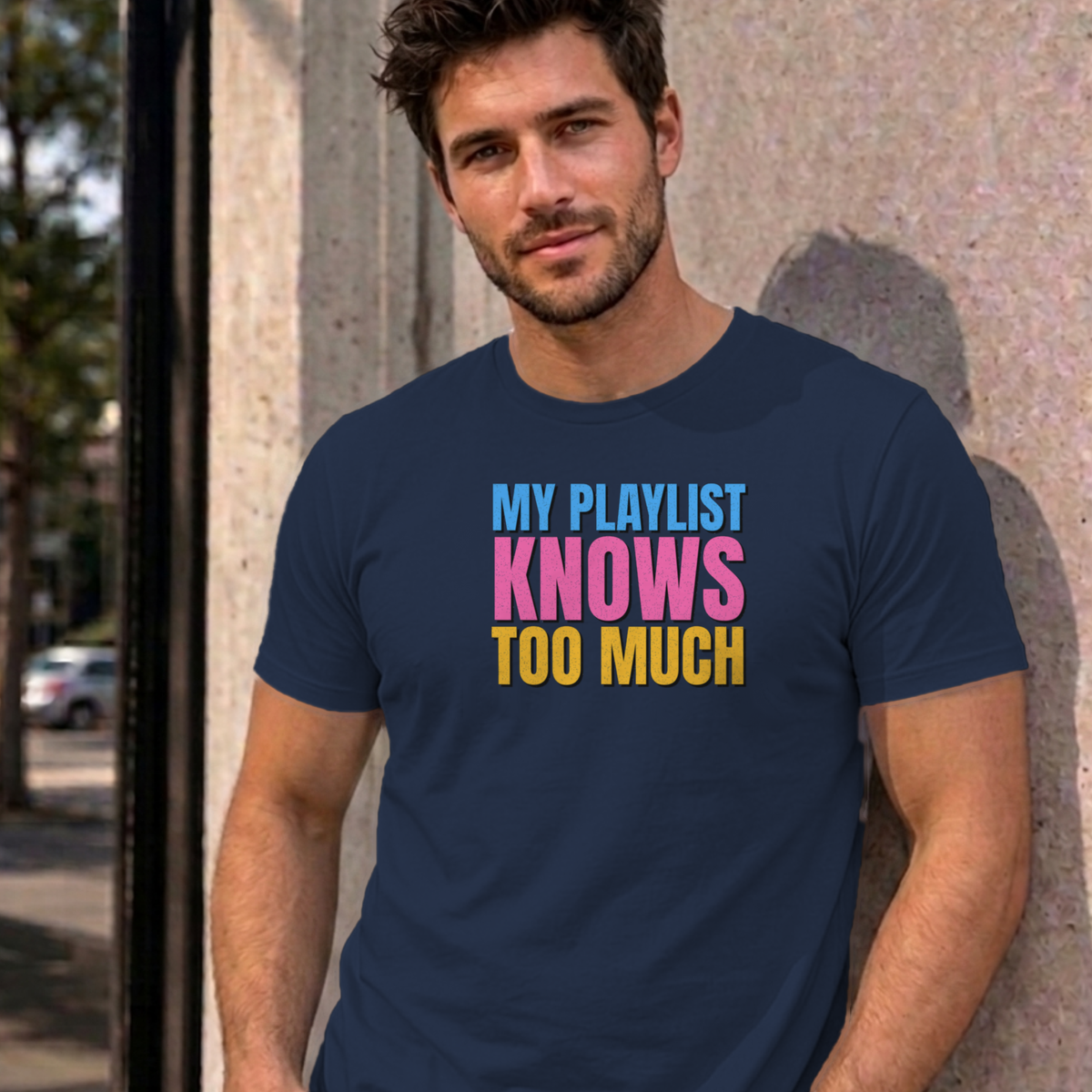 Man wearing the navy My Playlist Knows Too Much graphic tee