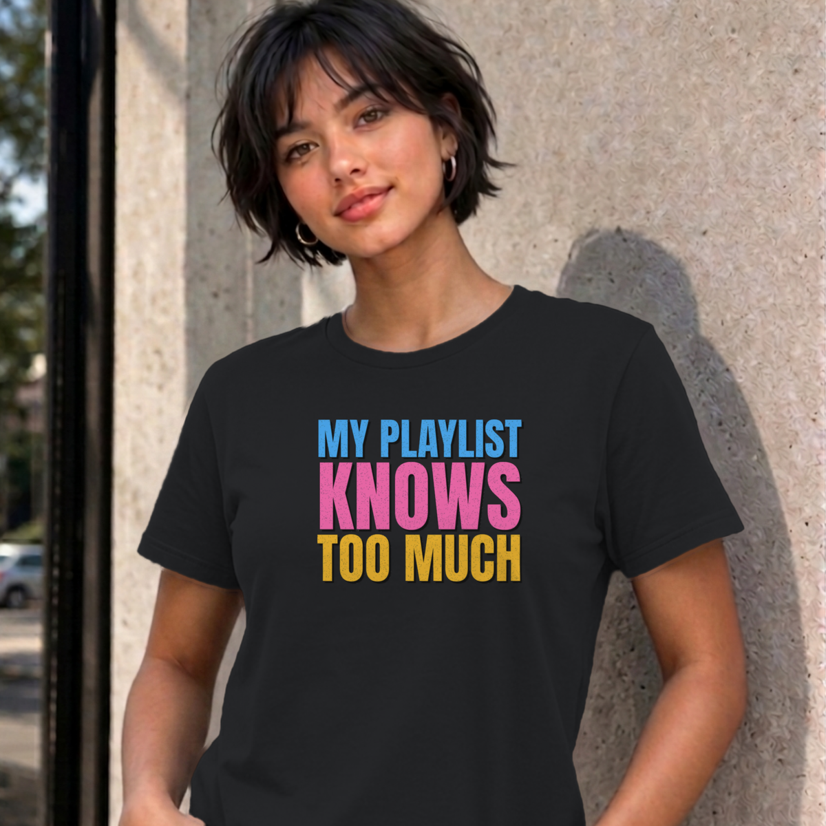 Woman wearing the black My Playlist Knows Too Much graphic tee