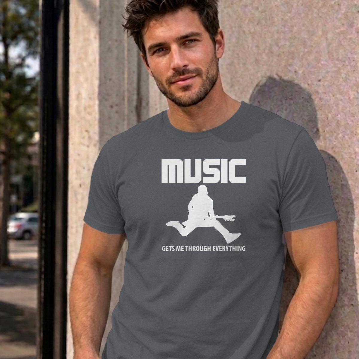Man wearing the charcoal Music Gets Me Through graphic tee