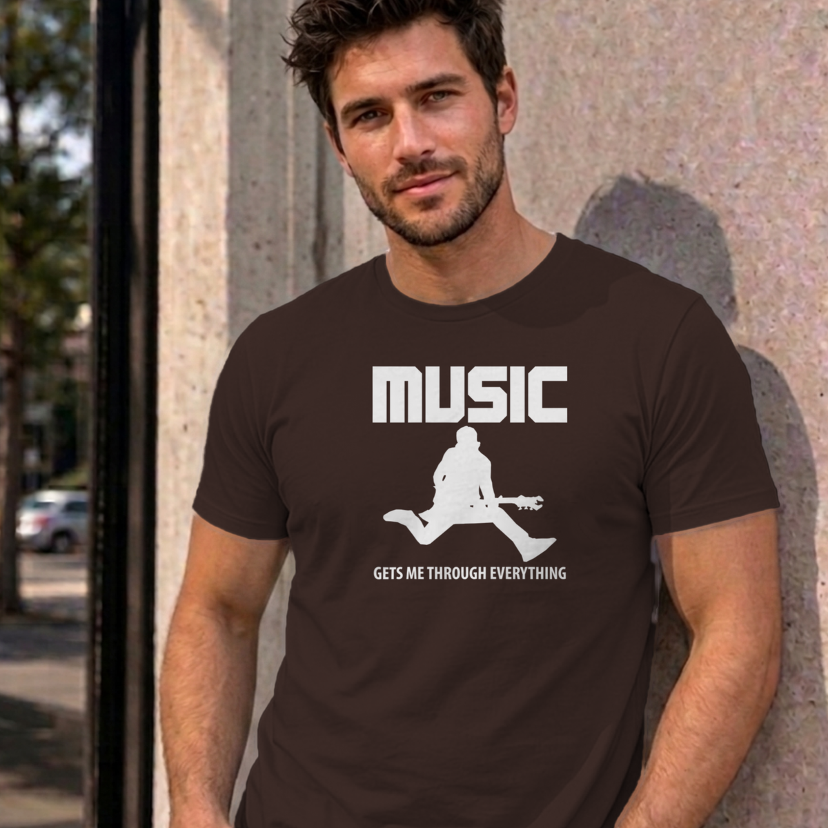 Man wearing the dark chocolate Music Gets Me Through graphic tee