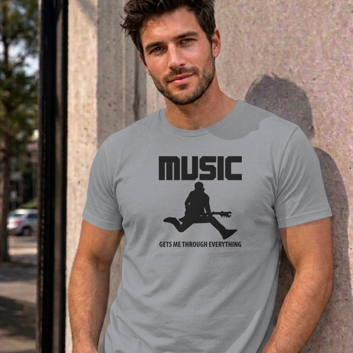 Man wearing the sport grey Music Gets Me Through graphic tee