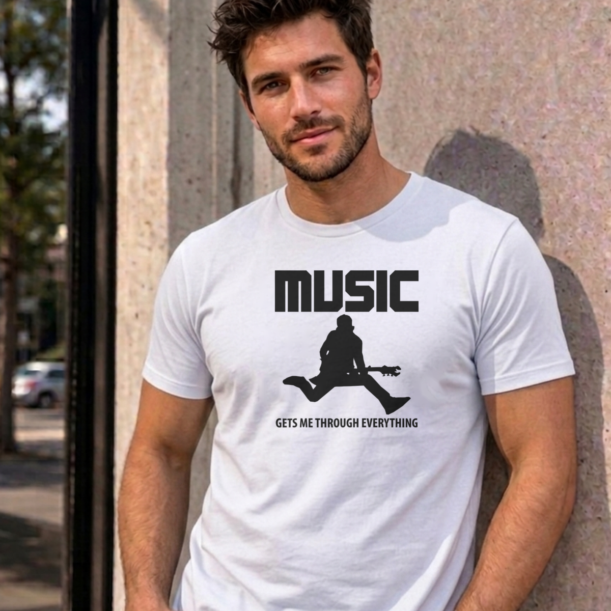 Man wearing the white Music Gets Me Through graphic tee