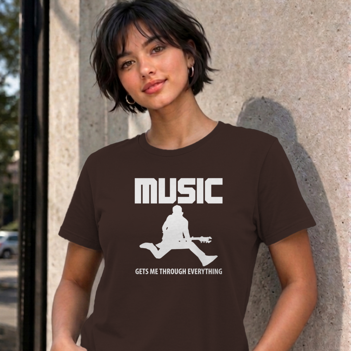 Woman wearing the dark chocolate Music Gets Me Through graphic tee