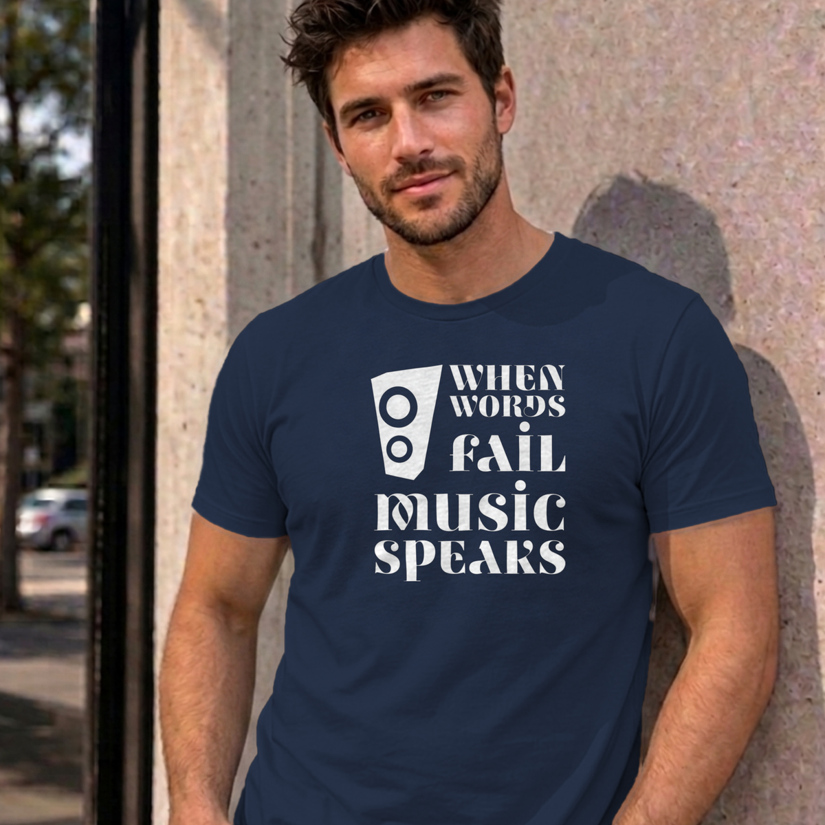 Man wearing the navy Music Speaks graphic tee