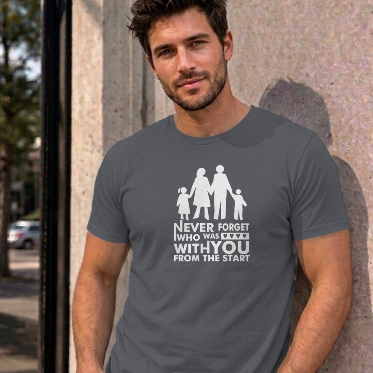 Man wearing the charcoal Never Forget Family graphic tee