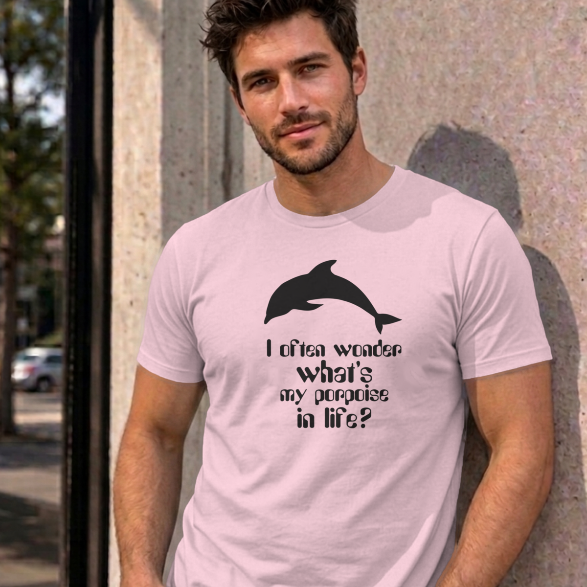 Man wearing the light pink I Often Wonder graphic tee