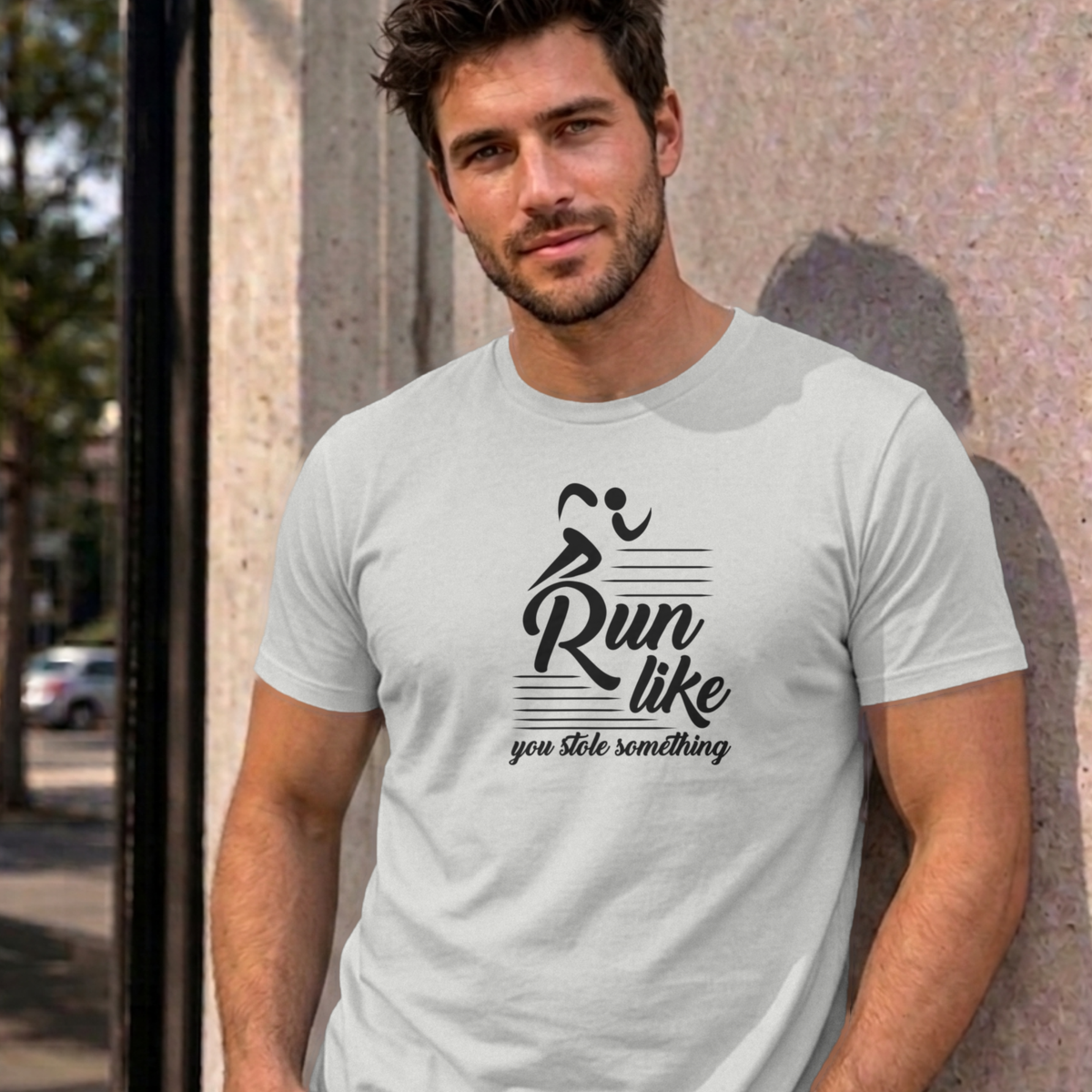 Man wearing the ash Run Like You Stole Something graphic tee