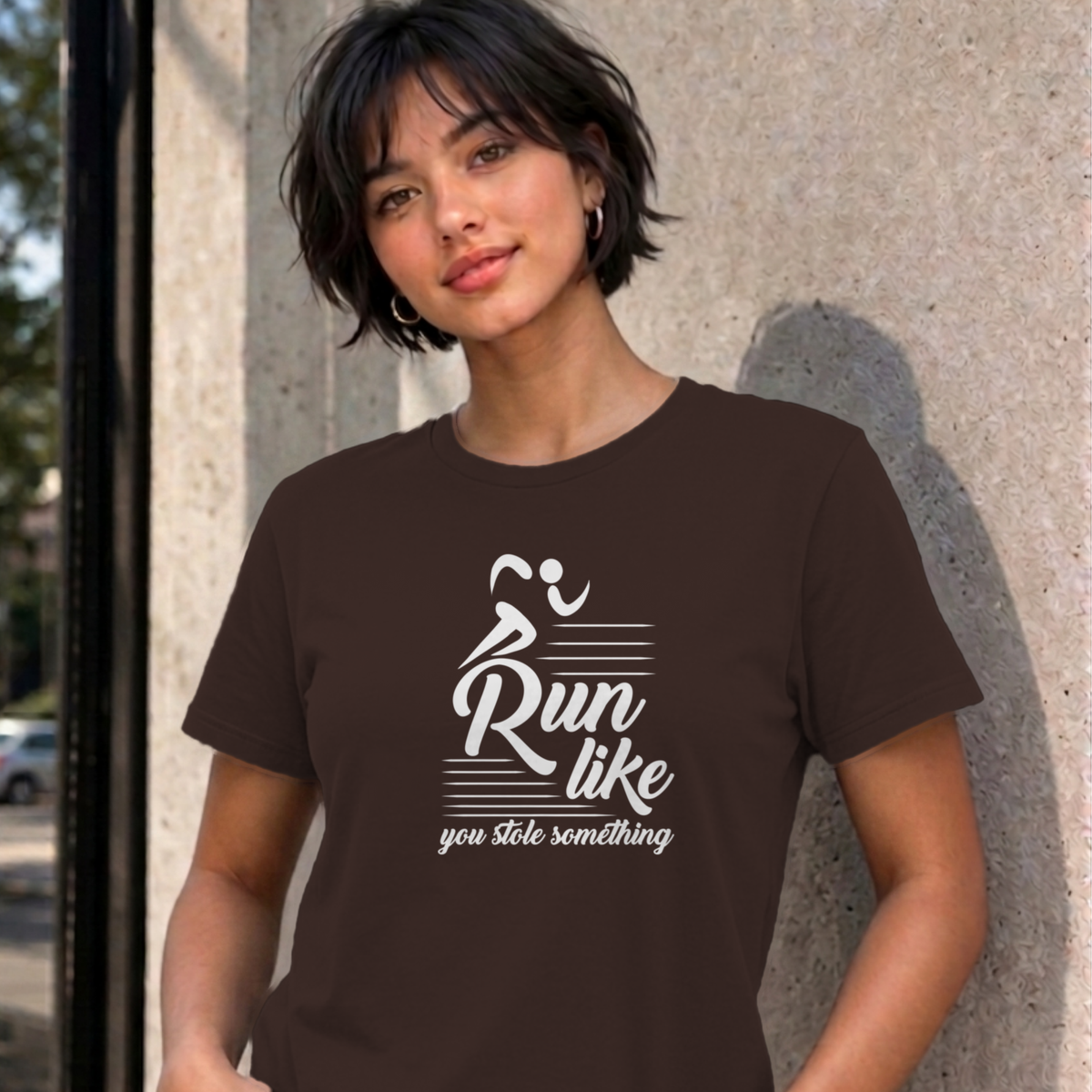 Woman wearing the dark chocolate Run Like You Stole Something graphic tee