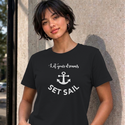 Woman wearing the black Let Your Dreams Set Sail graphic tee