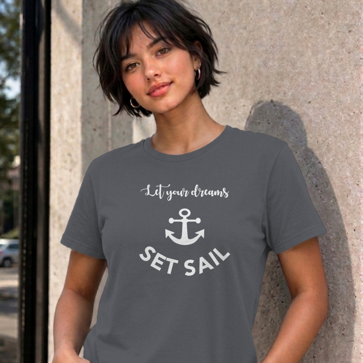 Woman wearing the charcoal Let Your Dreams Set Sail graphic tee