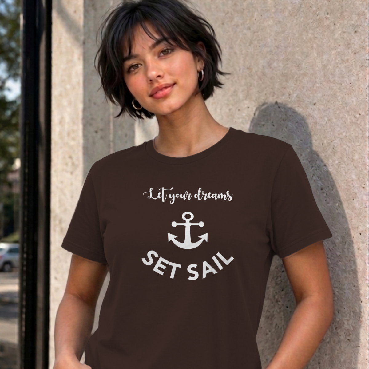 Woman wearing the dark chocolate Let Your Dreams Set Sail graphic tee