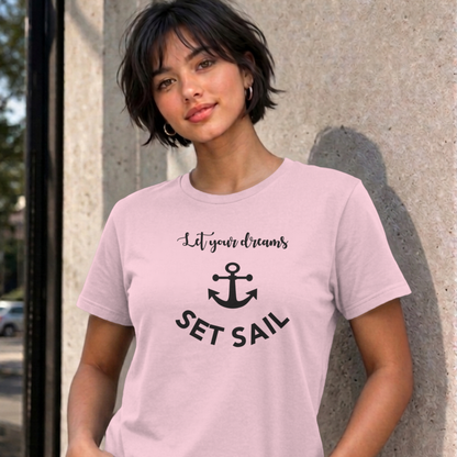 Woman wearing the light pink Let Your Dreams Set Sail graphic tee