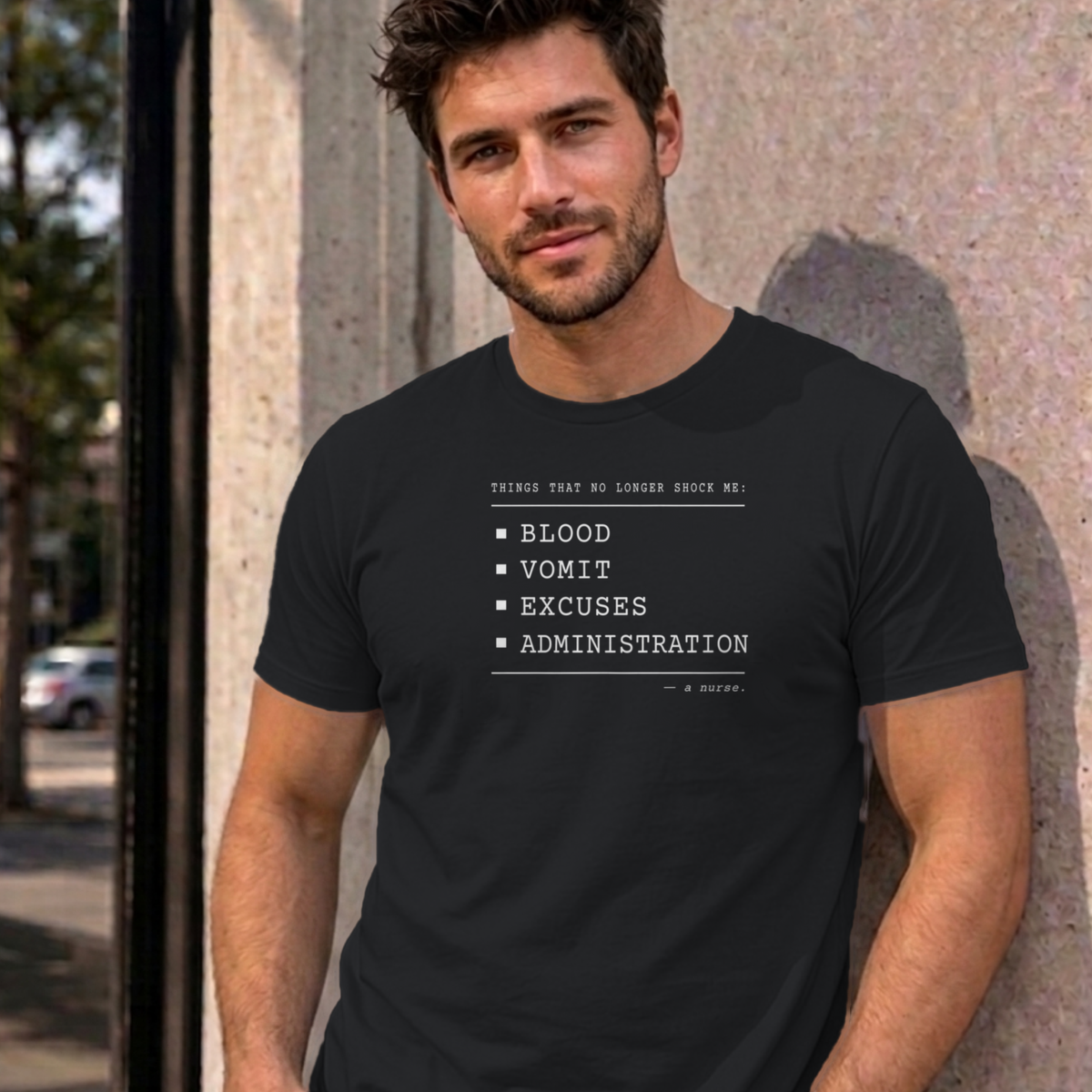 Man wearing the black Nurse No Longer Shocked graphic tee