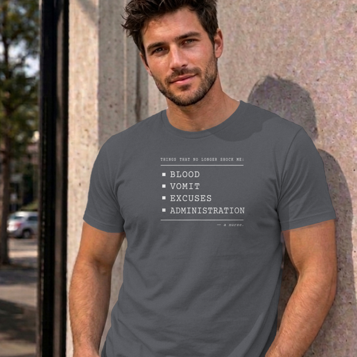Man wearing the charcoal Nurse No Longer Shocked graphic tee
