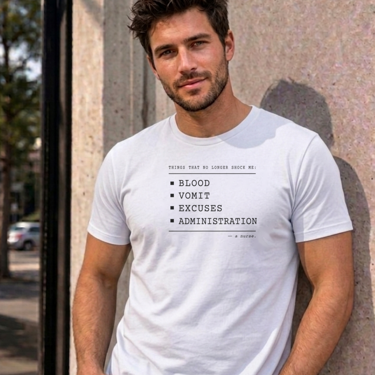 Man wearing the white Nurse No Longer Shocked graphic tee