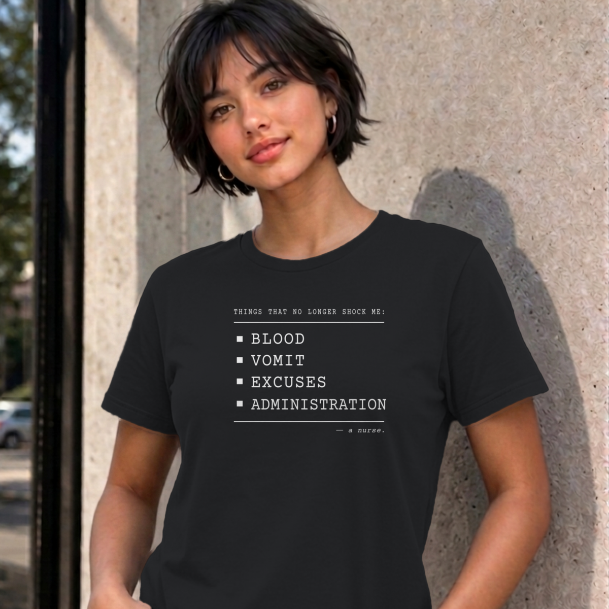 Woman wearing the black Nurse No Longer Shocked graphic tee