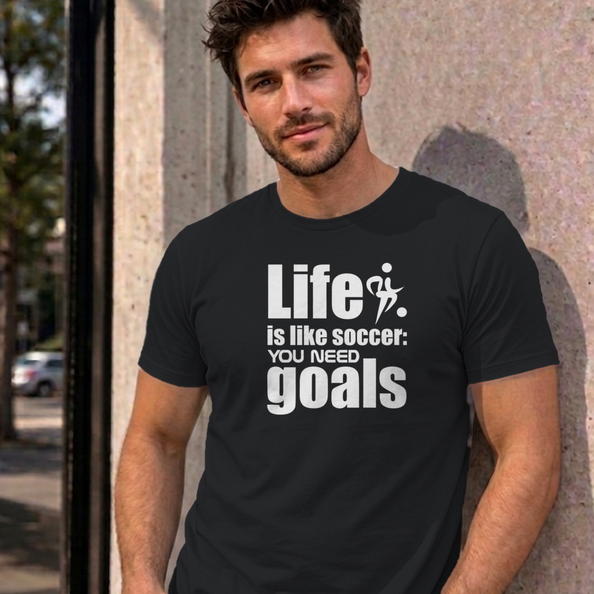 Man wearing the black Life Is Like Soccer graphic tee
