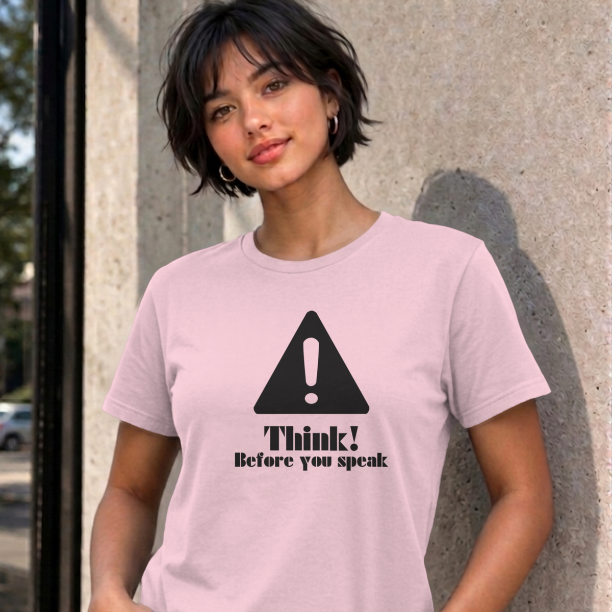 Woman wearing the light pink Think Before You Speak graphic tee