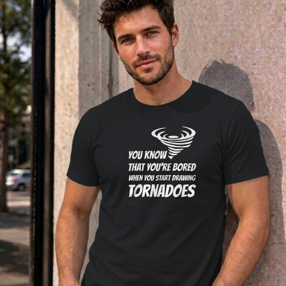 Man wearing the black Drawing Tornadoes graphic tee