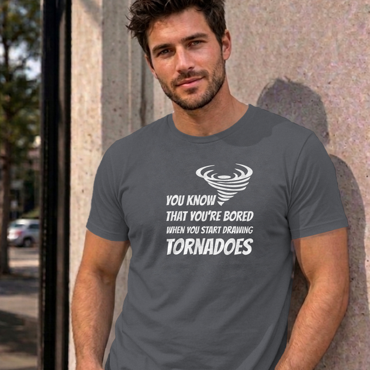 Man wearing the charcoal Drawing Tornadoes graphic tee