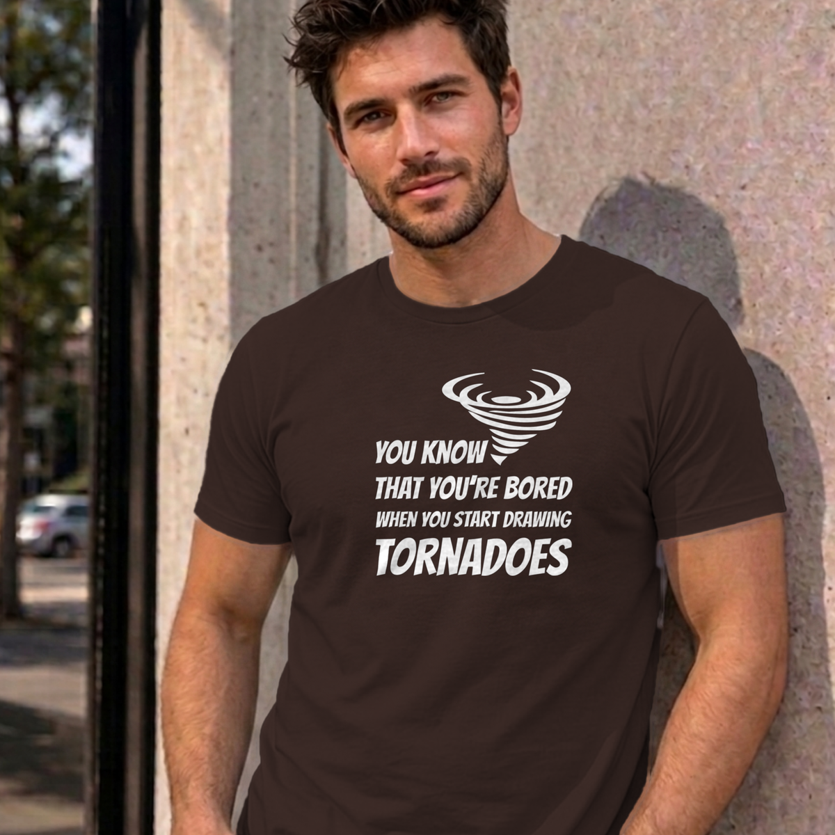 Man wearing the dark chocolate Drawing Tornadoes graphic tee