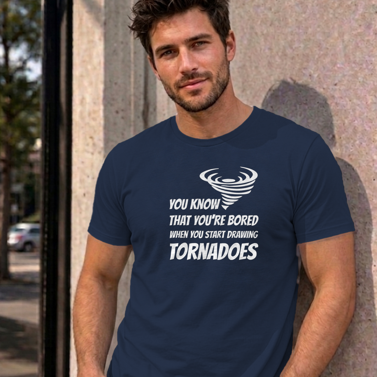 Man wearing the navy Drawing Tornadoes graphic tee
