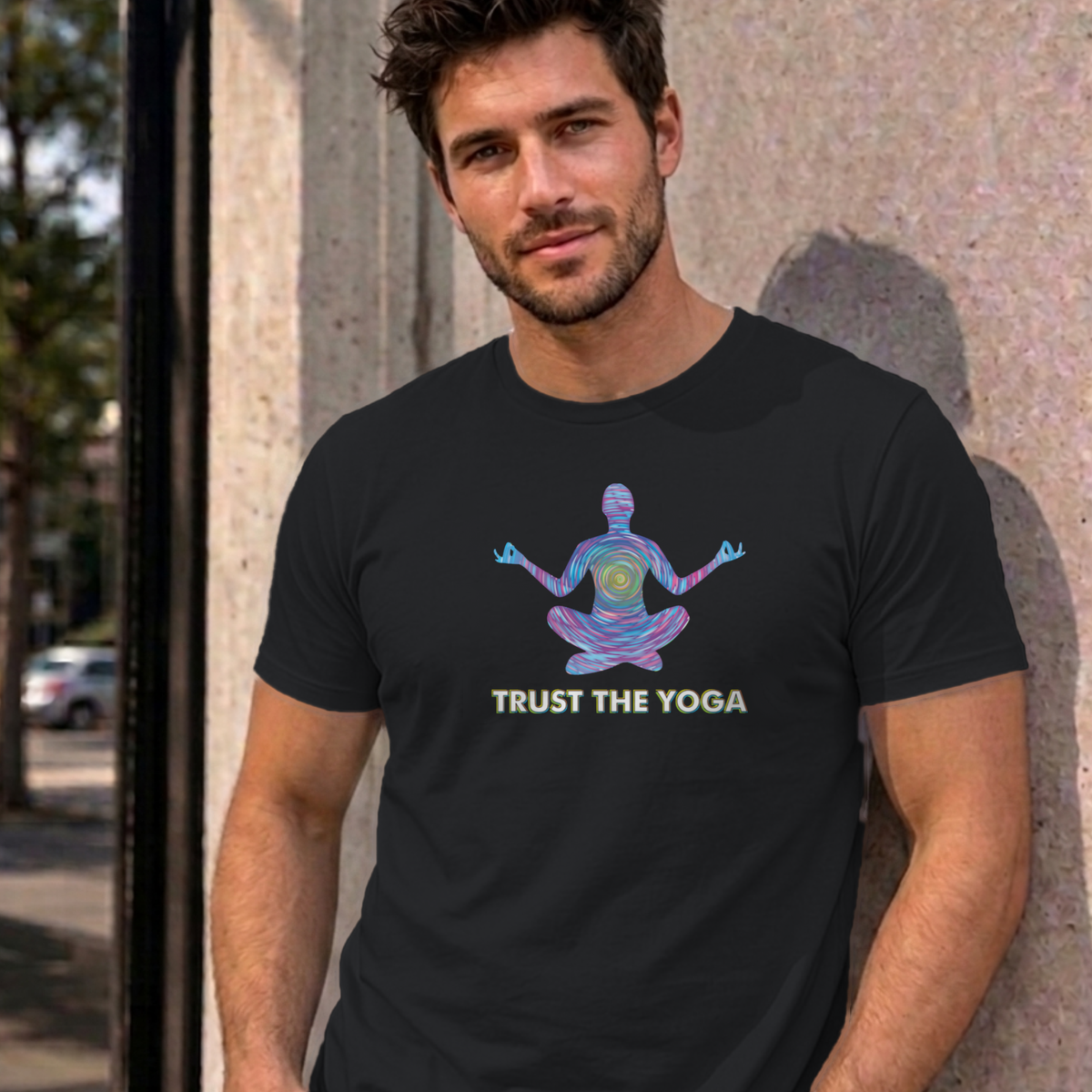 Man wearing the black Trust the Yoga graphic tee