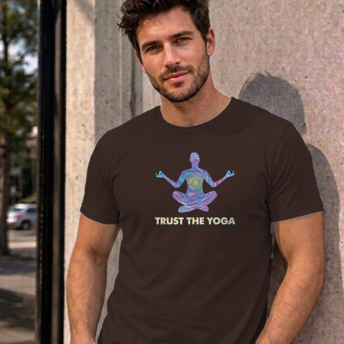 Man wearing the dark chocolate Trust the Yoga graphic tee