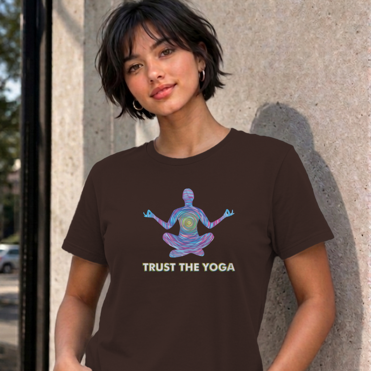 Woman wearing the dark chocolate Trust the Yoga graphic tee