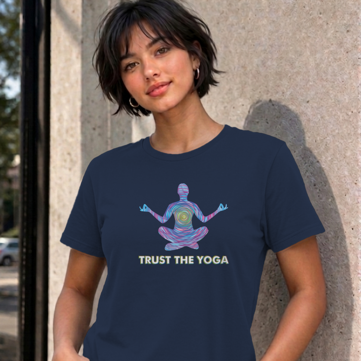 Woman wearing the navy Trust the Yoga graphic tee