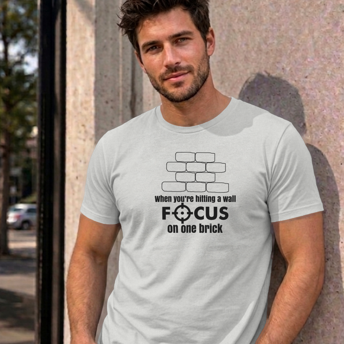 Man wearing the ash Focus on One Brick graphic tee