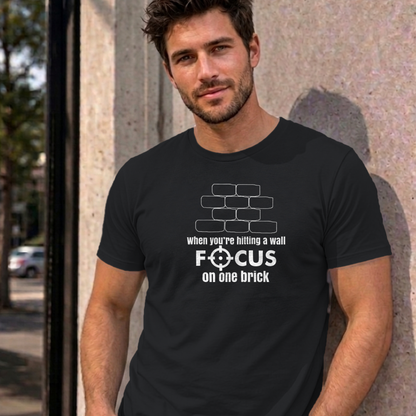 Man wearing the black Focus on One Brick graphic tee