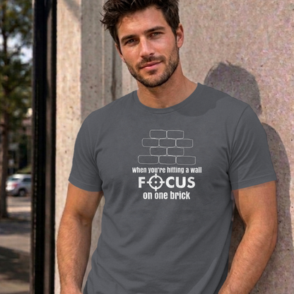 Man wearing the charcoal Focus on One Brick graphic tee