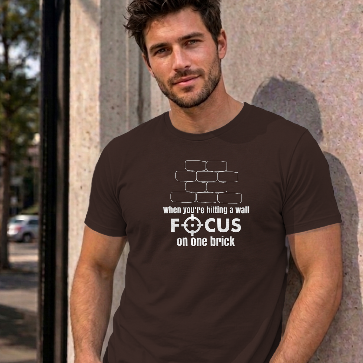Man wearing the dark chocolate Focus on One Brick graphic tee