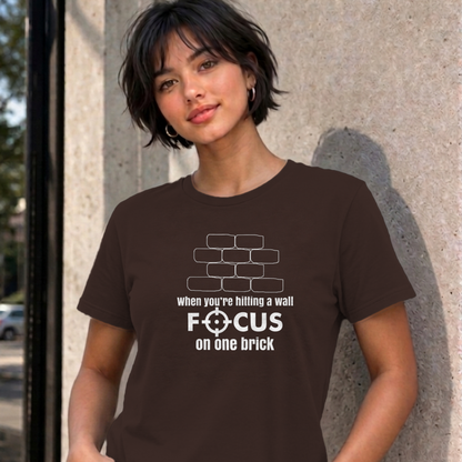 Woman wearing the dark chocolate Focus on One Brick graphic tee