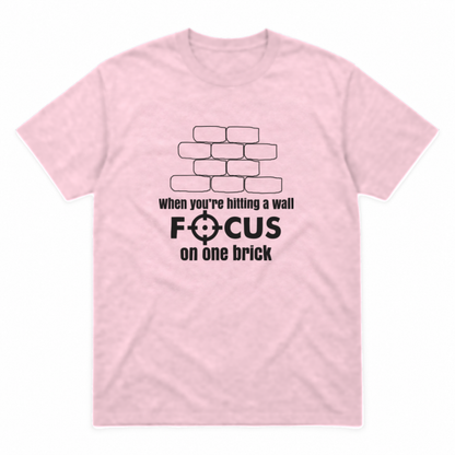 Focus on One Brick graphic tee in light pink with black print, front view
