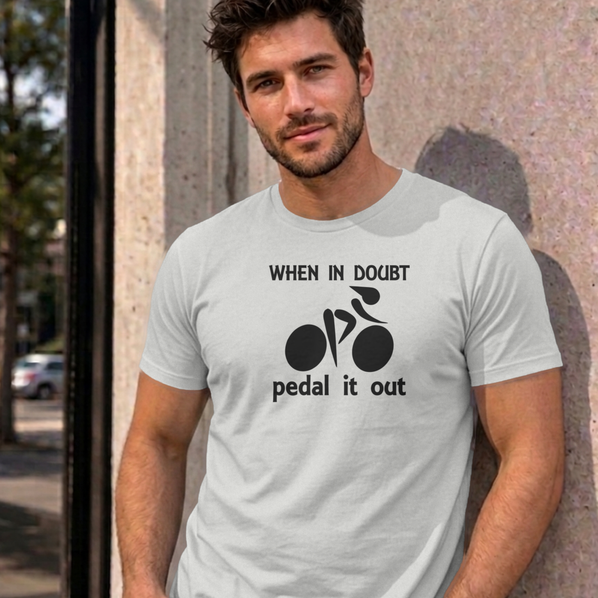 Man wearing the ash Pedal It Out graphic tee