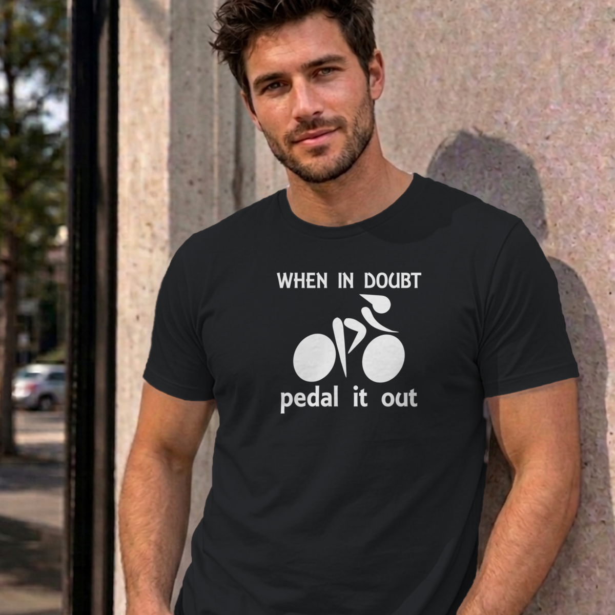 Man wearing the black Pedal It Out graphic tee