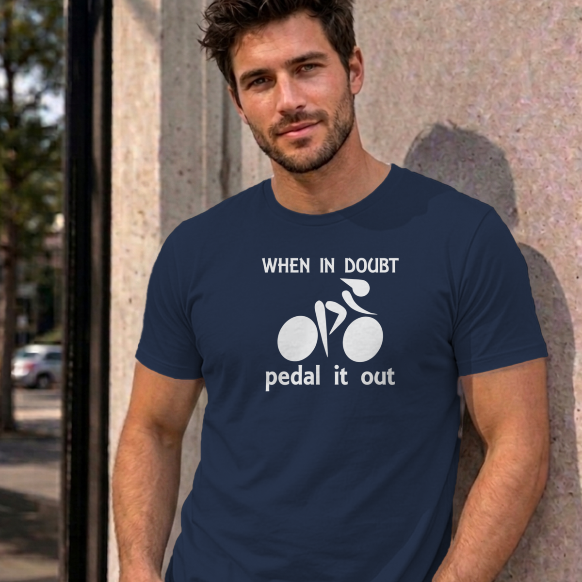 Man wearing the navy Pedal It Out graphic tee