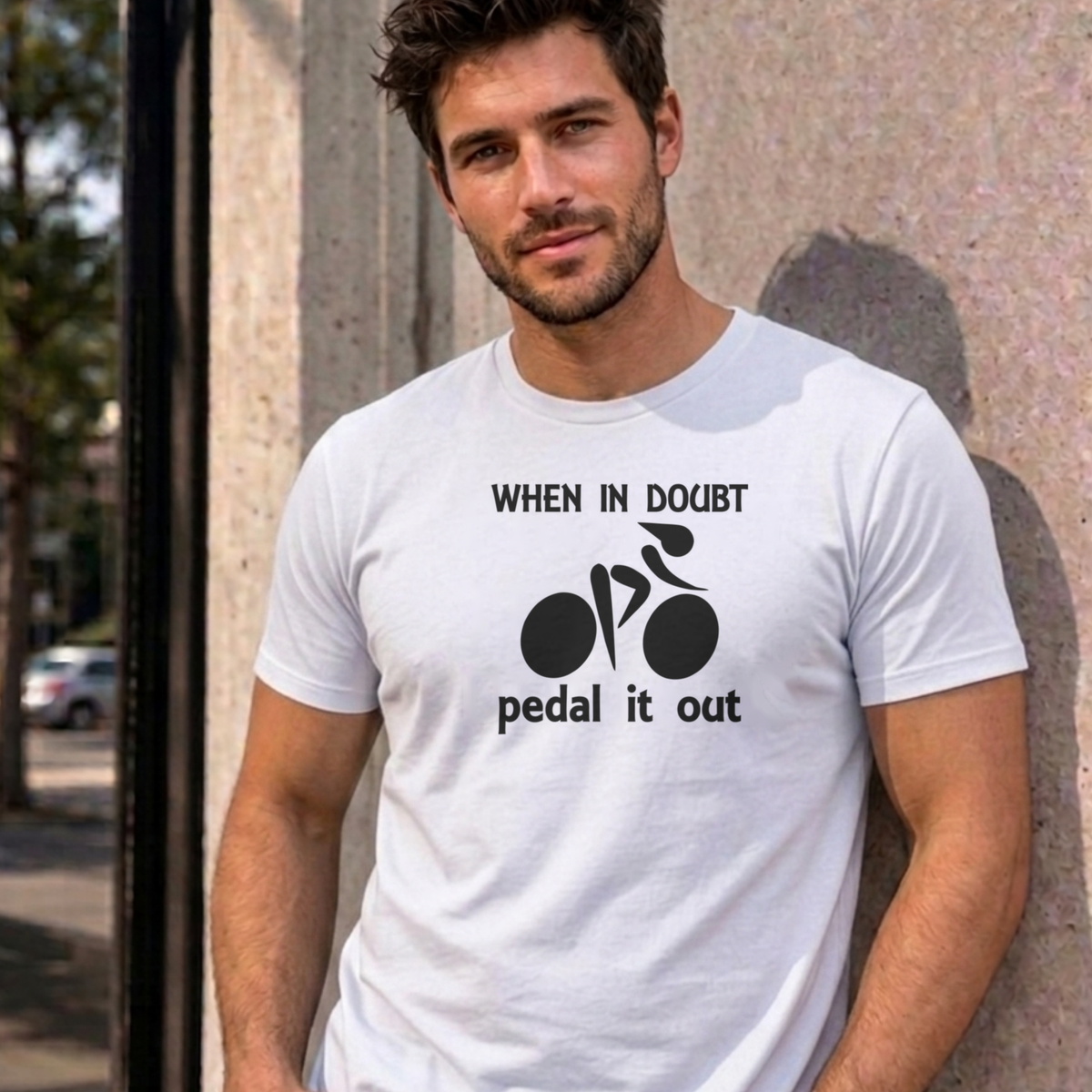 Man wearing the white Pedal It Out graphic tee