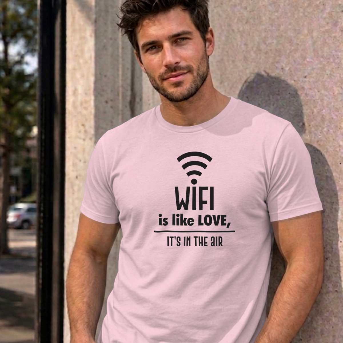Man wearing the light pink Wifi Is Like Love graphic tee