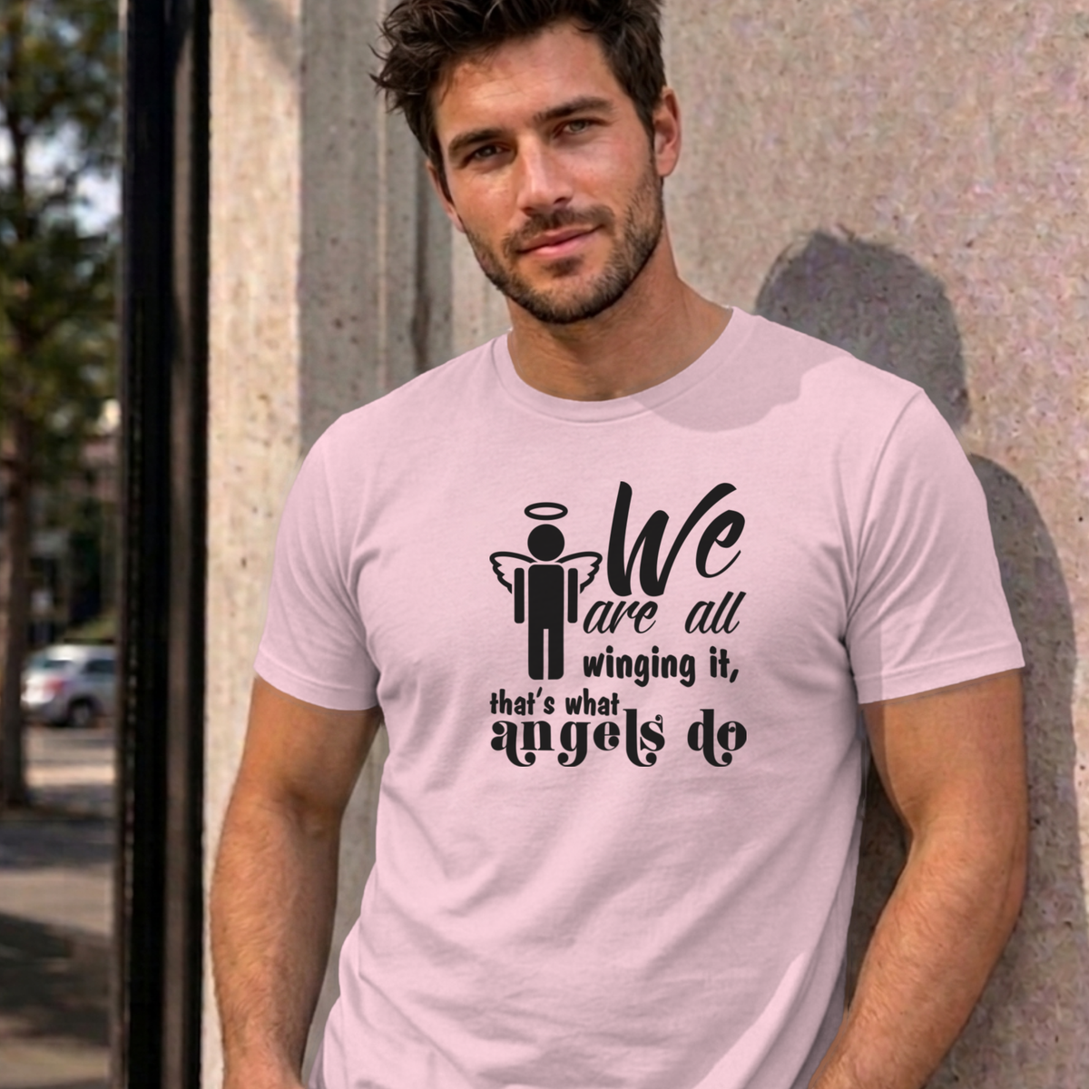Man wearing the light pink Winging It graphic tee